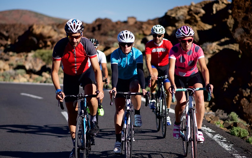 cyclists ride in groups